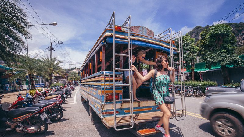 Girl getting off a bus in Thailand