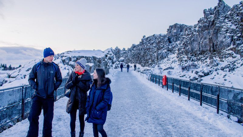 Three travellers in the snow in Iceland