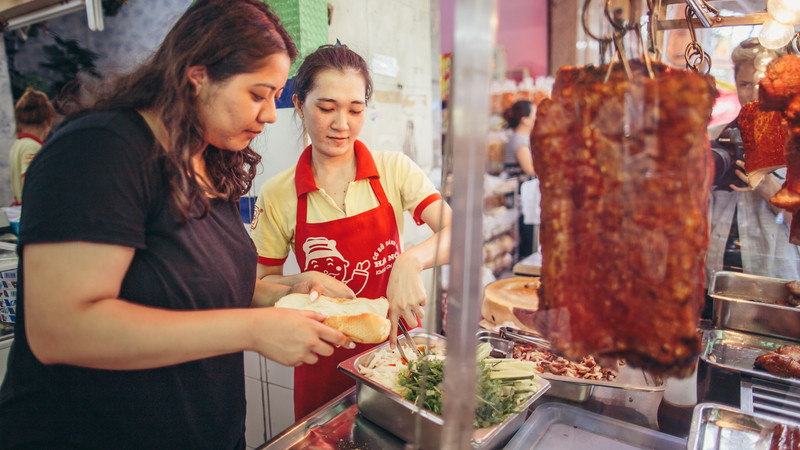 Two women making a sandwich in Vietnam