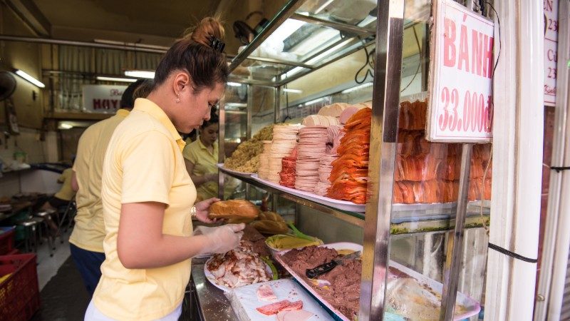 A woman in Vietnam making sandwiches