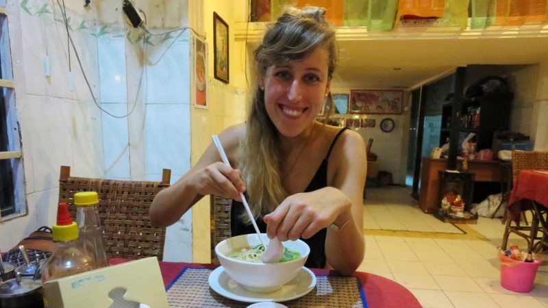 Woman eating noodles in Vietnam