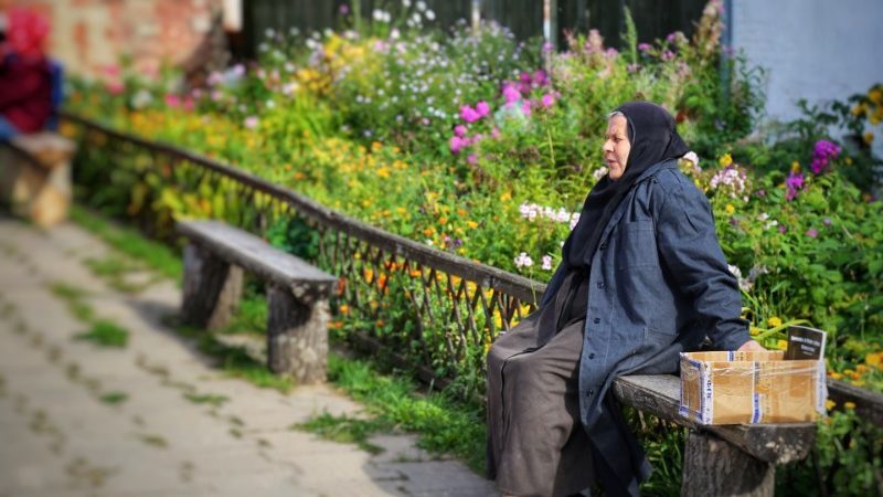 A Russian woman sits in a garden