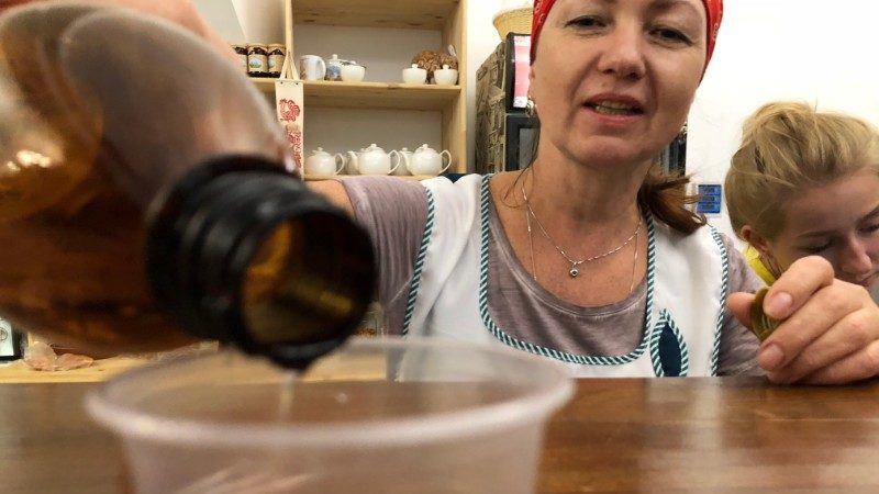 A woman pours a glass of mead in Russia