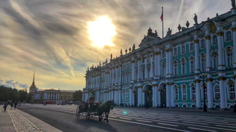 The sun sets behind a beautiful old building in Russia