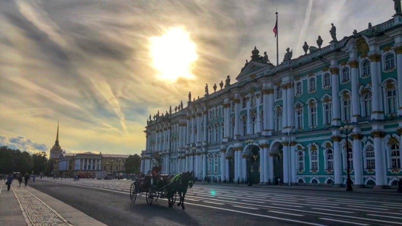 The sun sets behind a beautiful old building in Russia