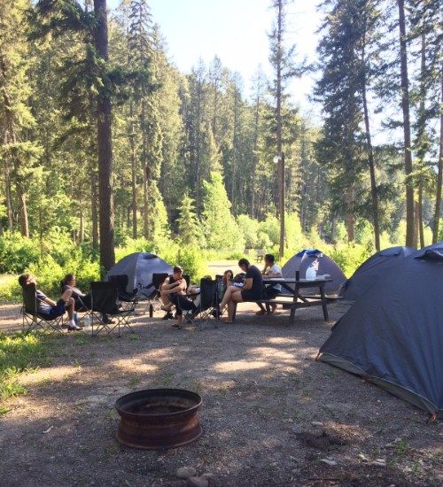 Travellers sitting around a campsite