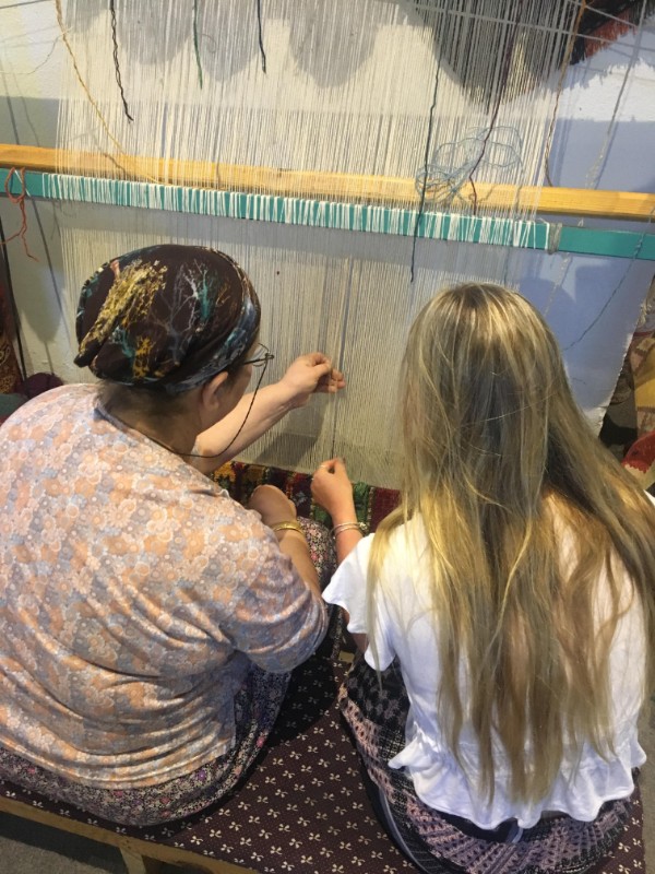 Young local woman teachers traveller to weave