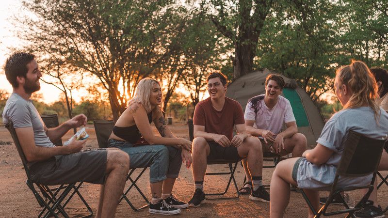 Travellers sitting around a campsite