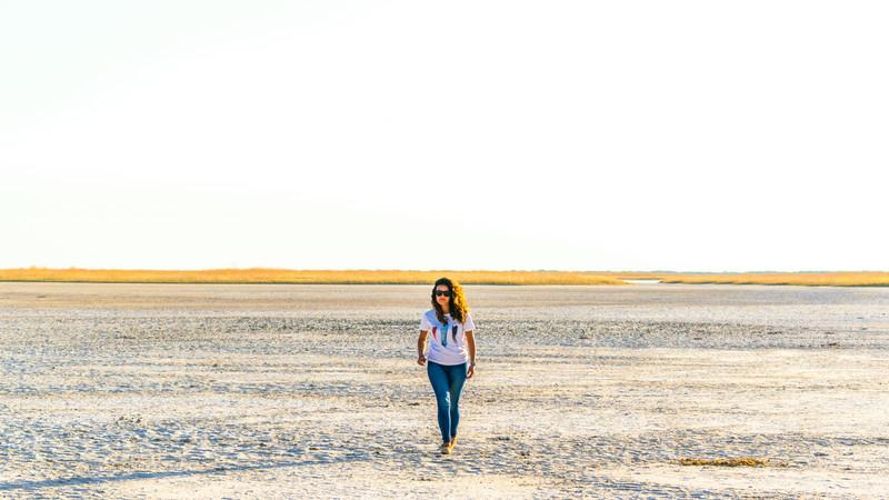 a woman walking on the Makgadikgadi salt pan.