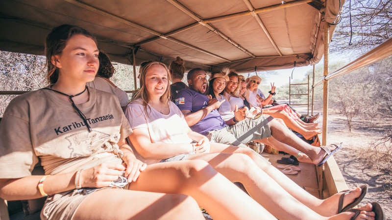 A group of travellers on a safari vehicle