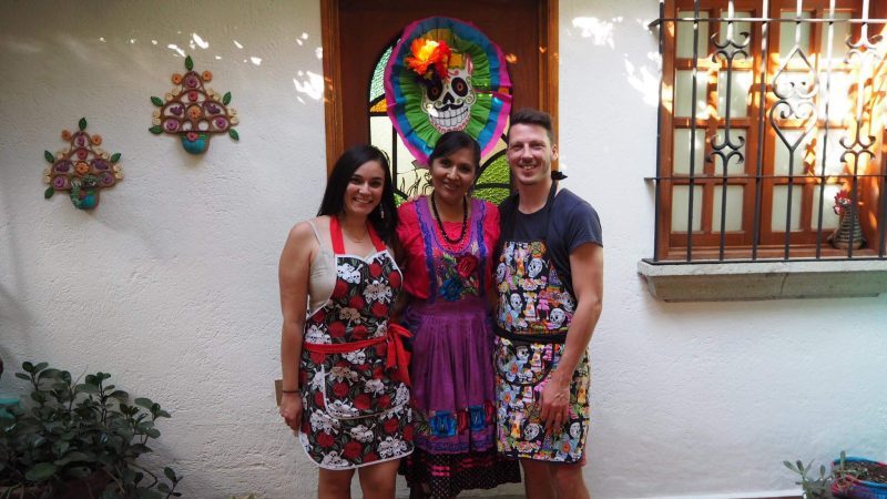 Three people wearing aprons. 