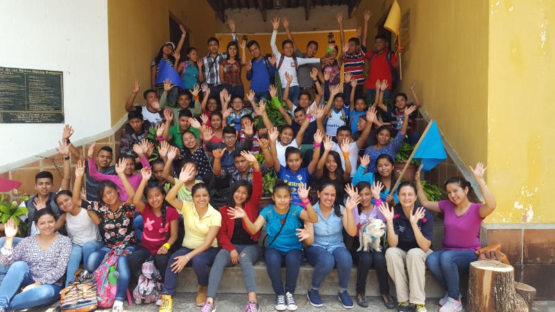 A big group of students sitting on some steps