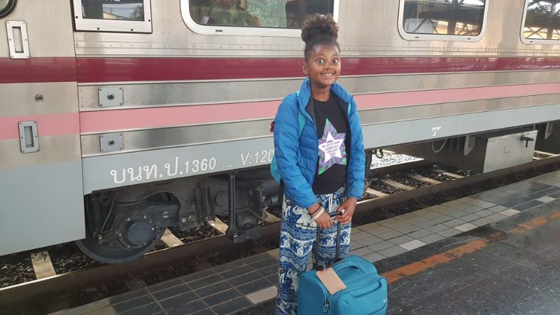 Girl getting on a train in Thailand