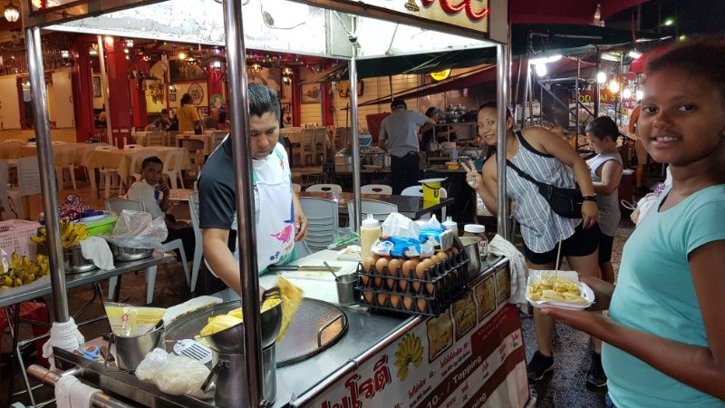 Girl in Thailand buying street food