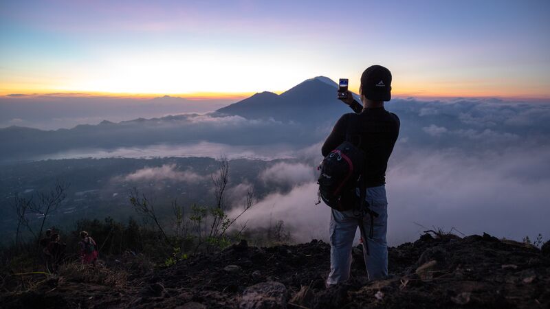 Traveller takes photo at Mt Batur, Bali. 