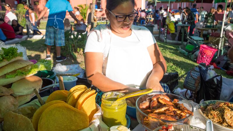 A woman preparing food at a market