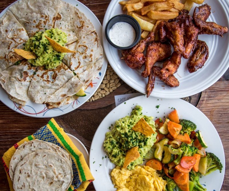 Plates of chicken, vegetables and bread