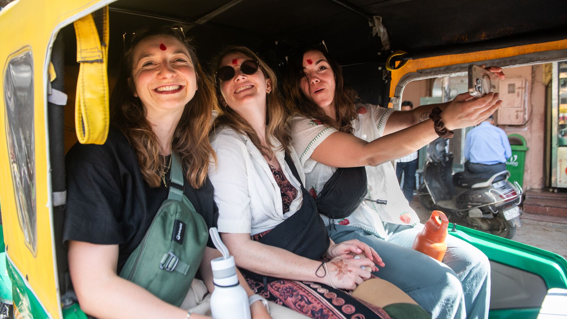 Intrepid travellers riding a rickshaw in India.