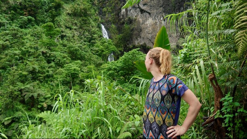 A girl looks at a waterfall in Fiji