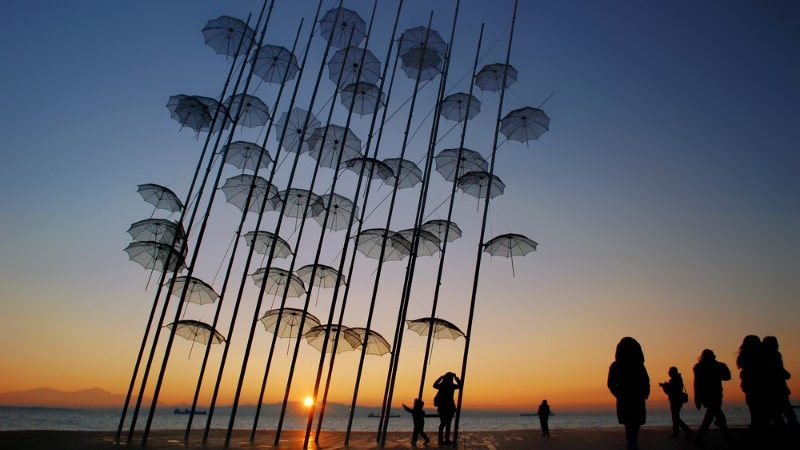 Umbrella statue with sunset in the background