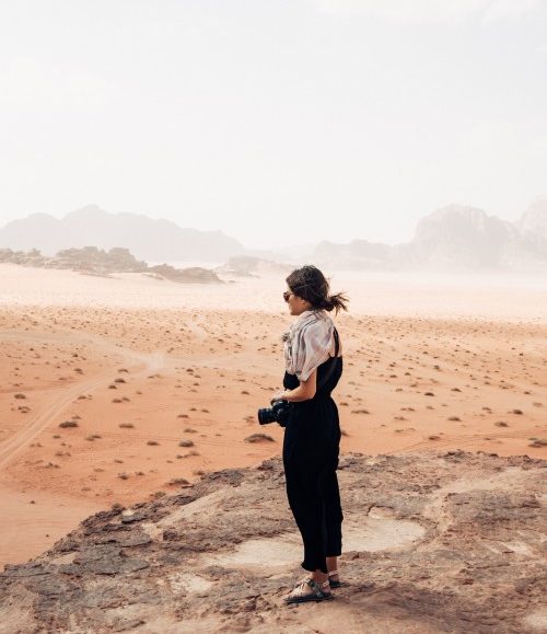 A woman looks out over the desert