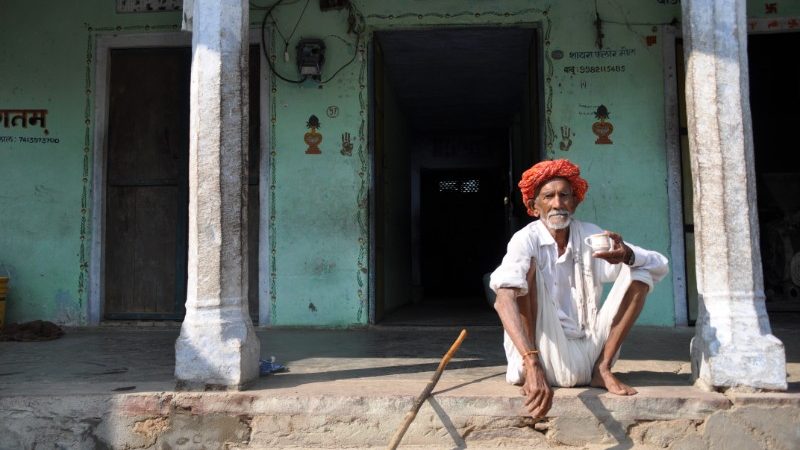 A man sitting outside his house