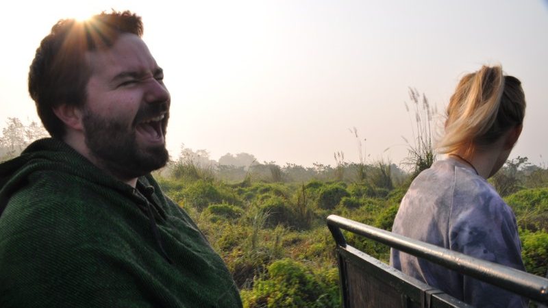 A man laughing in the back of a jeep