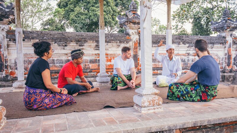 Travellers at a traditional ceremony in Bali.