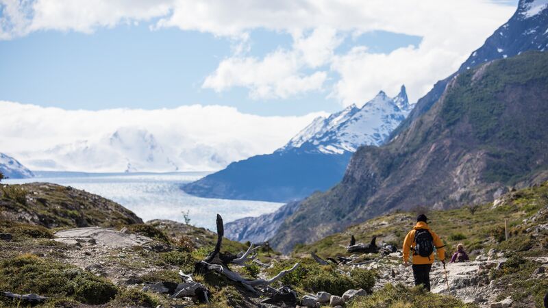 A trekker in a yellow jacket in Chilean Patagonia