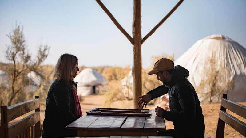 Two friends playing a board game in Uzbekistan