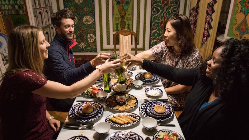 Four people cheers at dinner