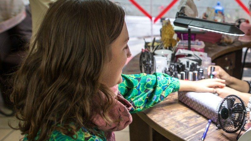 A girl getting her nails done.