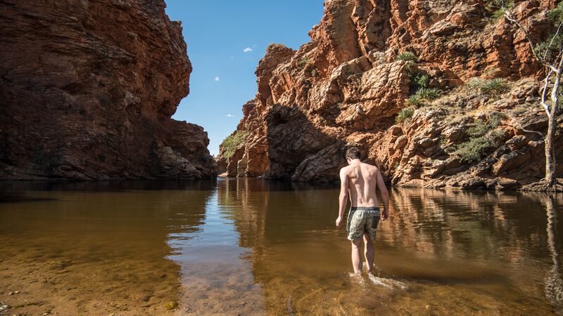 A man walks into a swimming hole in Australia