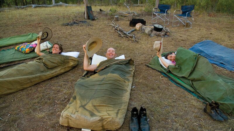 Travellers sleeping in swags.