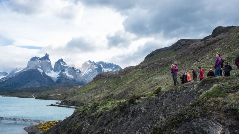 Hikers in Patagonia look out over the lake