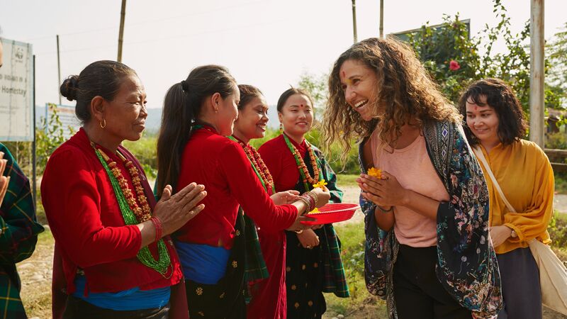 Local women in Nepal meeting two travellers