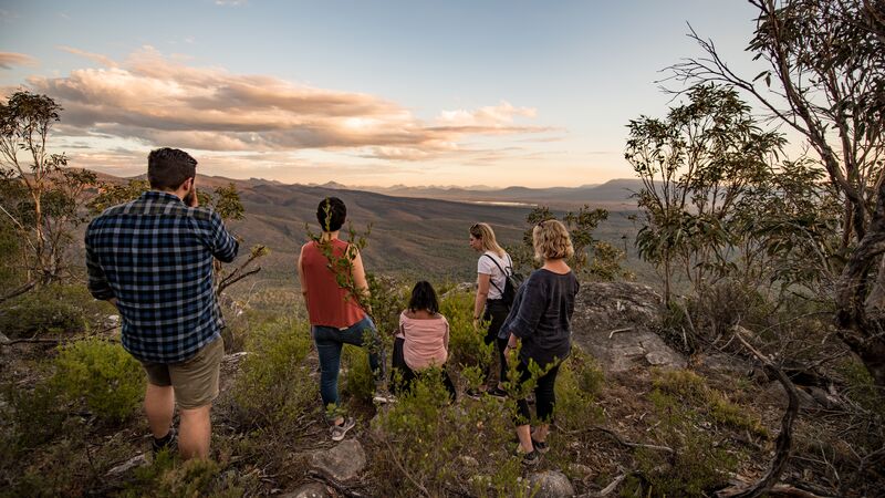 A group of people watch the sunset in regional Victoria