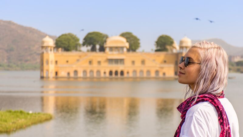 A young woman looking at a palace in India