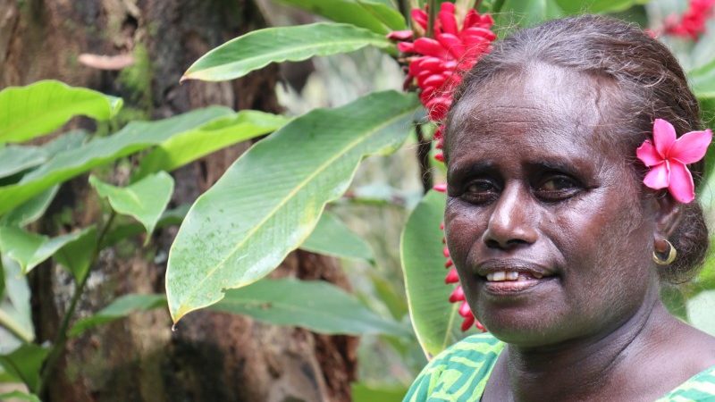 A woman with a flower behind her ear