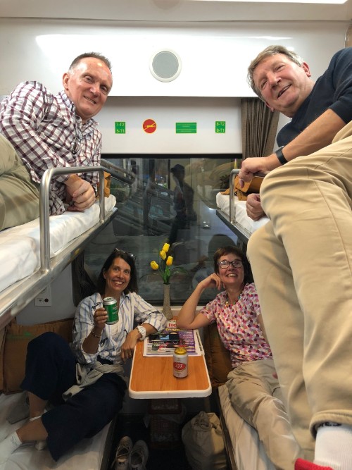 Four travellers in a cabin on an overnight train.