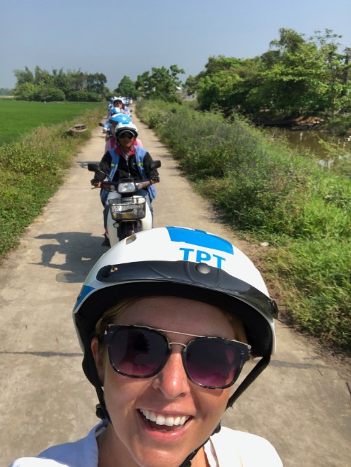 Selfie of a young woman on a motorbike.