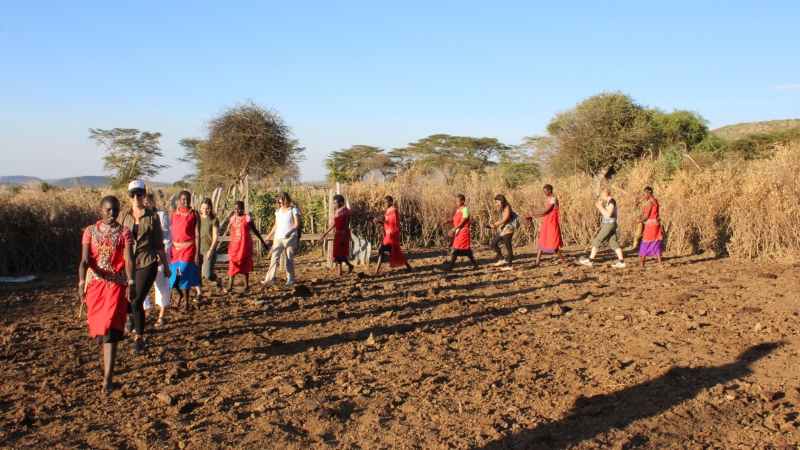 a group of women dancing in a circle on a Kenya safari