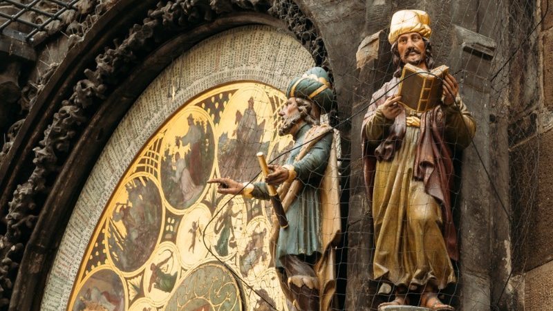 A huge clockface, with two statues alongside