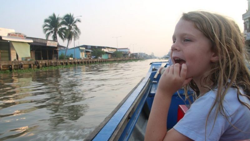 A young boy sitting on a boat in Vietnam