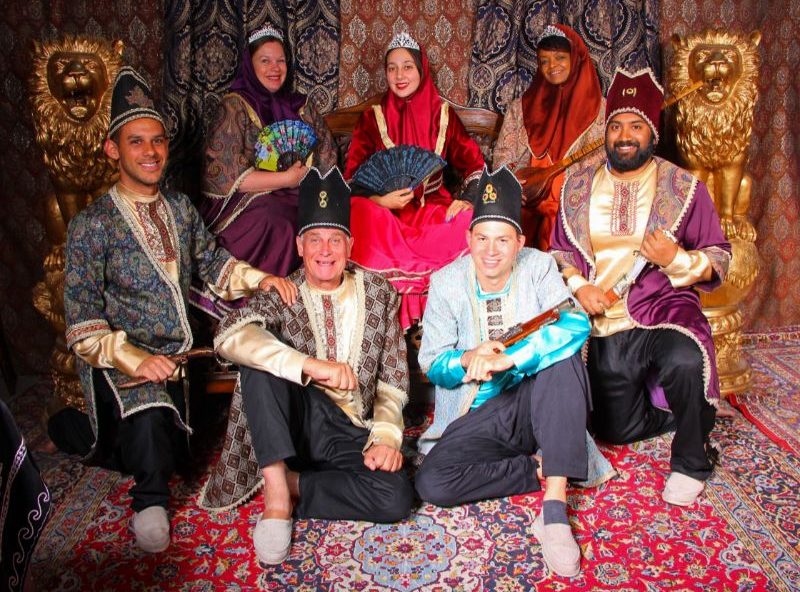 A group of travelers wearing traditional Persian outfits