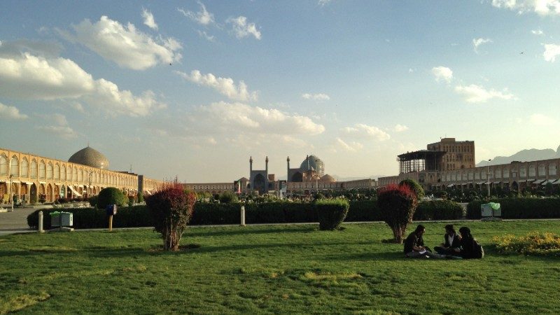 People sitting on a lawn in Iran