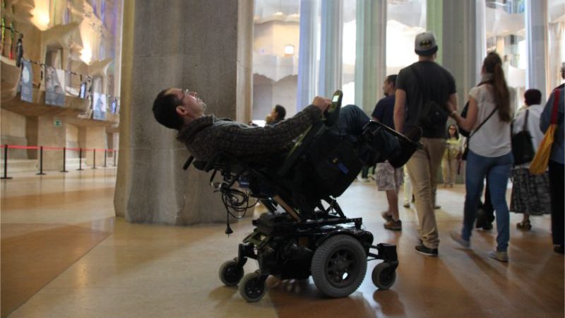 A man in a wheelchair admires the ceiling at Sagrada Familia