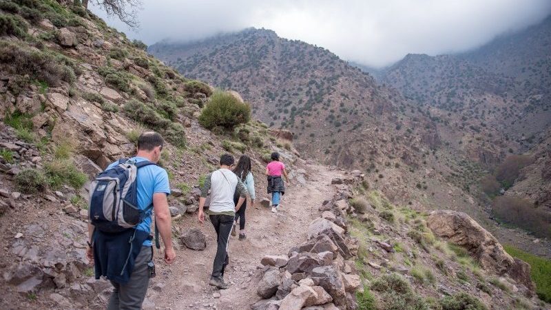 People hiking up a trail in the Altas mountains,