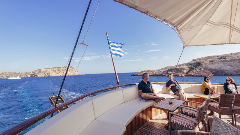 Two men sitting on the deck of a boat