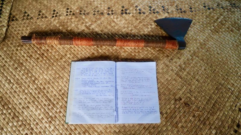 An axe and a guestbook on a table